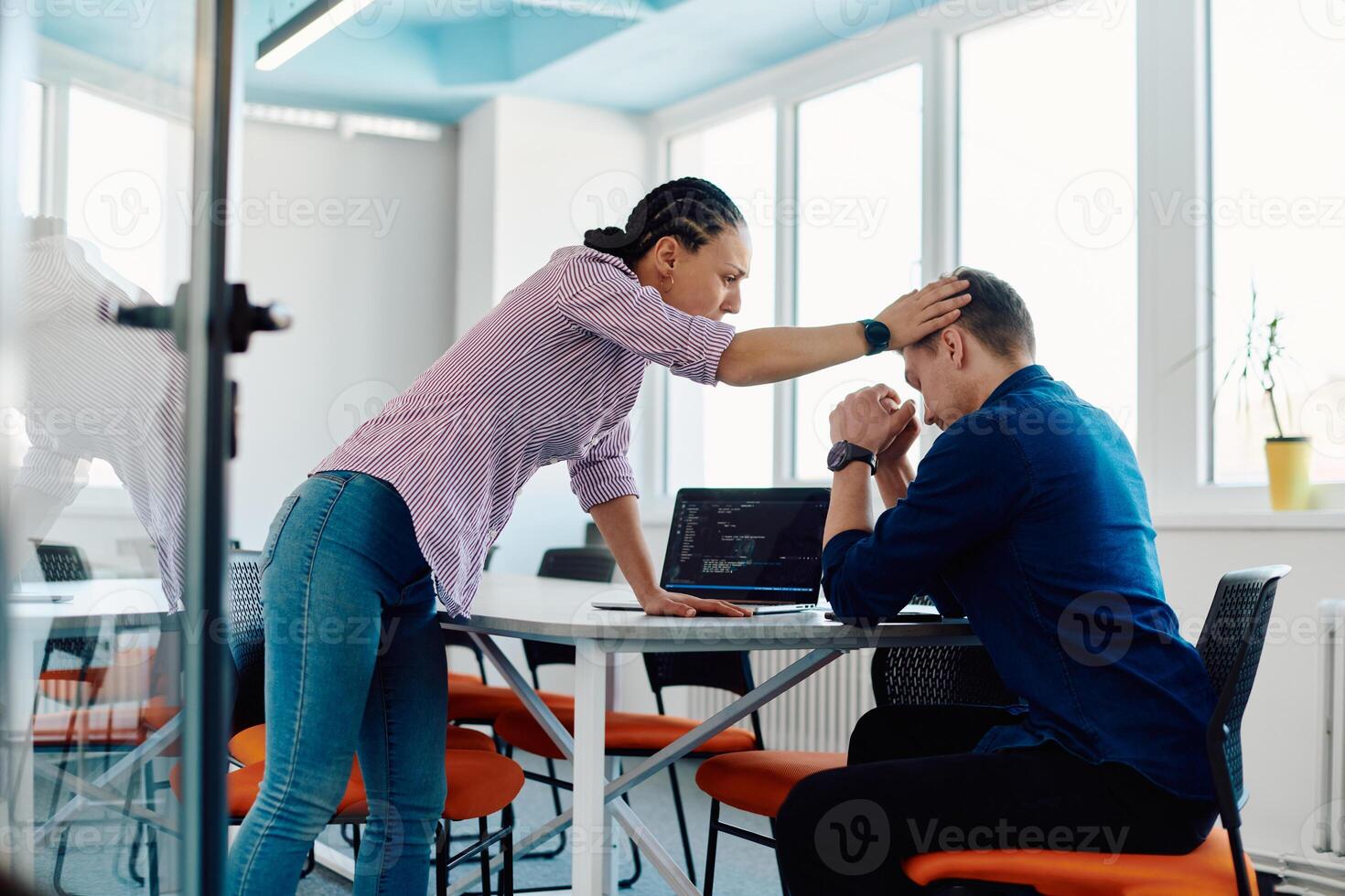 A furious business director of a startup office berating her employee for business mistakes and errors photo