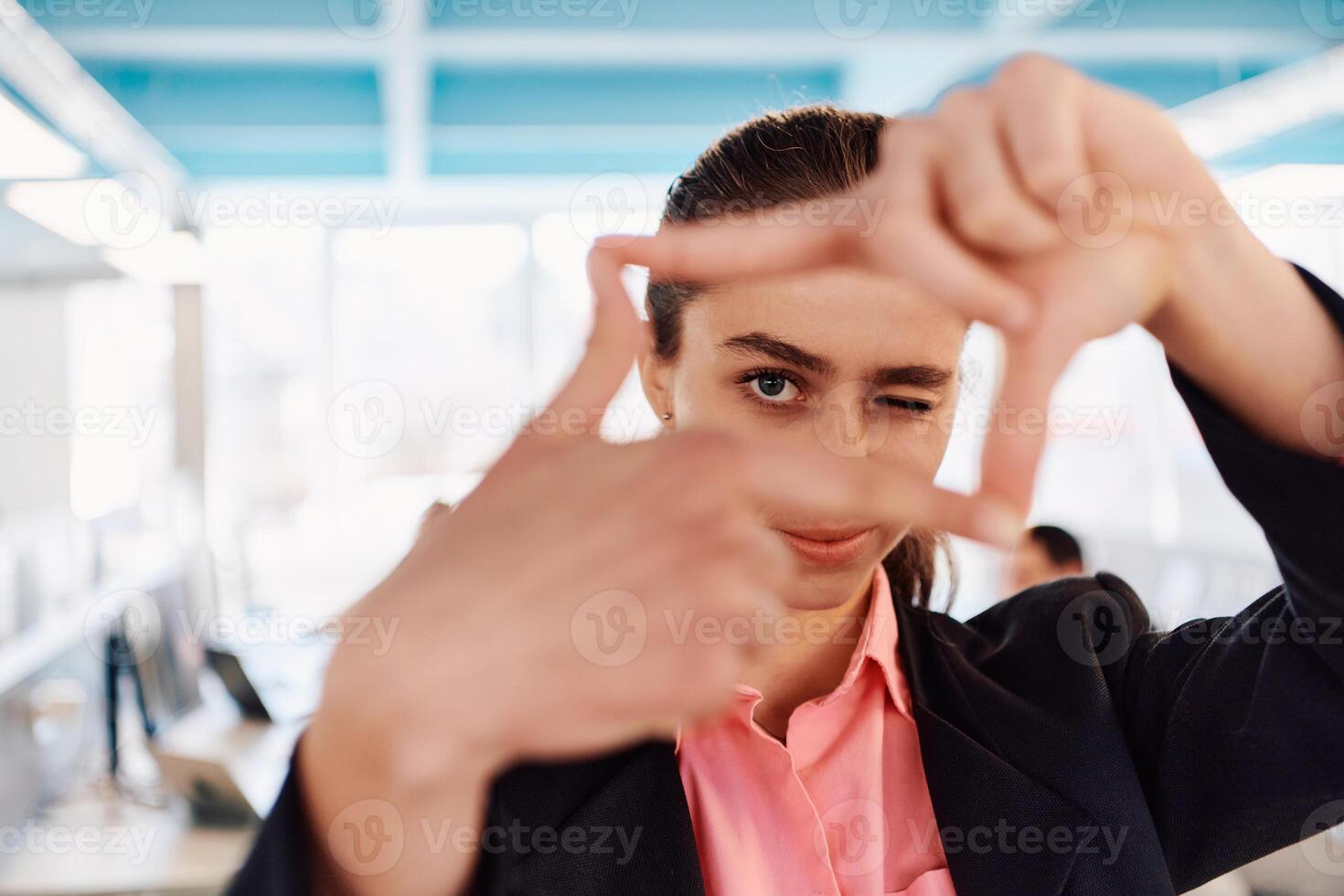 Closeup of hands, Smiling Business Woman Making Frame Gesture with at modern bright coworking open space startup office photo