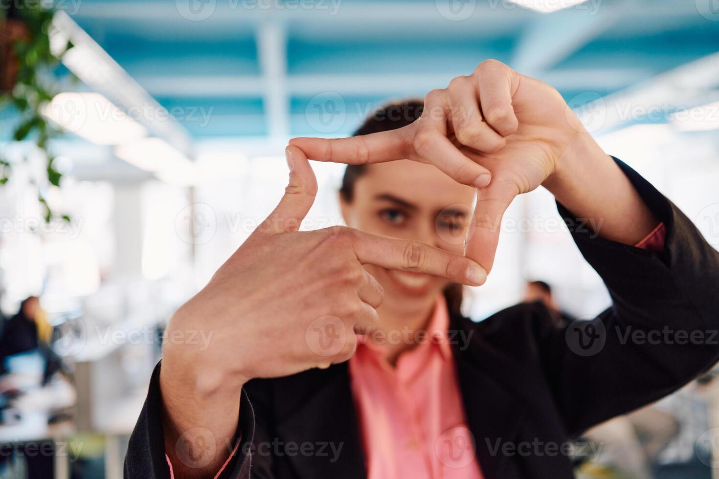 Closeup of hands, Smiling Business Woman Making Frame Gesture with at modern bright coworking open space startup office photo