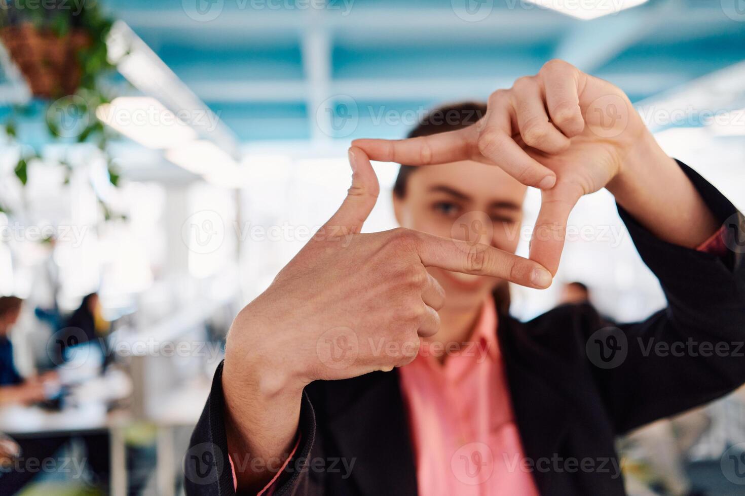 Closeup of hands, Smiling Business Woman Making Frame Gesture with at modern bright coworking open space startup office photo