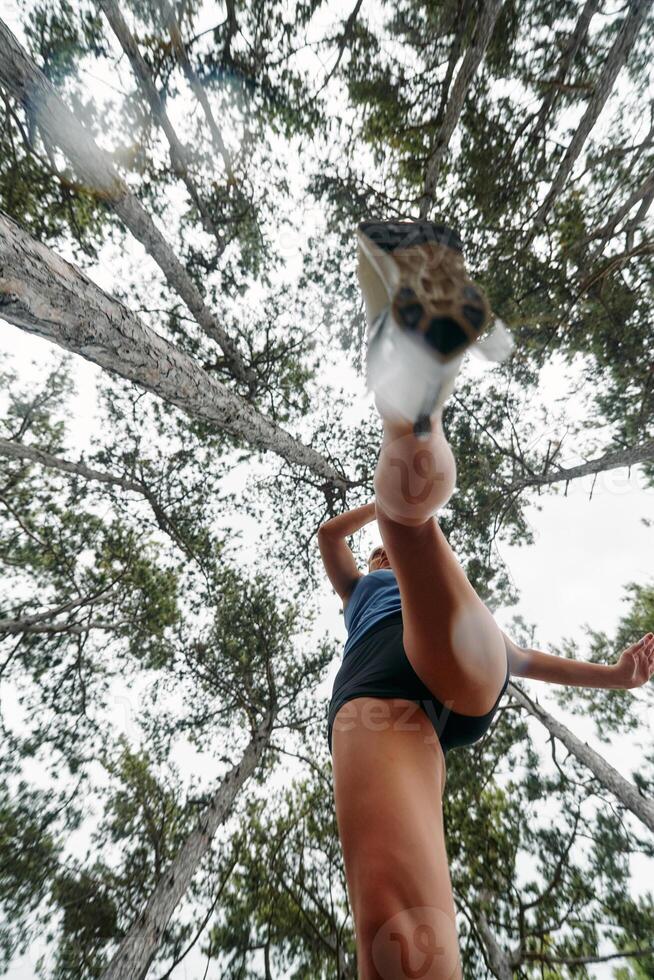 Adventurous Woman Overcoming Forest Obstacles with Determination and Agility. photo