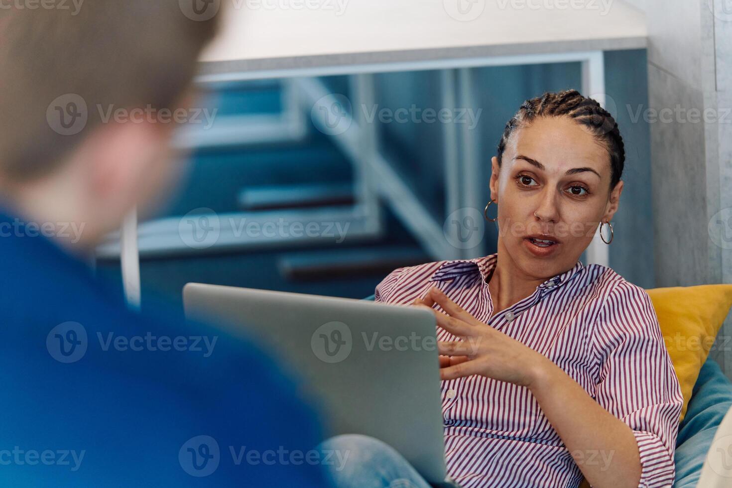 A modern programmer discussing future business projects with colleagues in a modern startup office photo