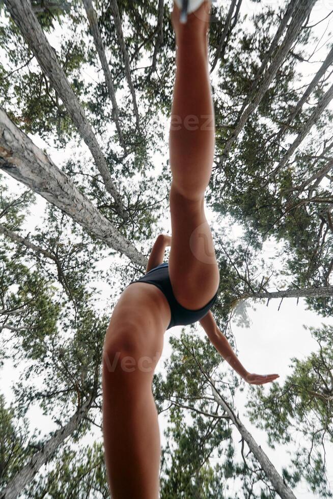 Adventurous Woman Overcoming Forest Obstacles with Determination and Agility. photo