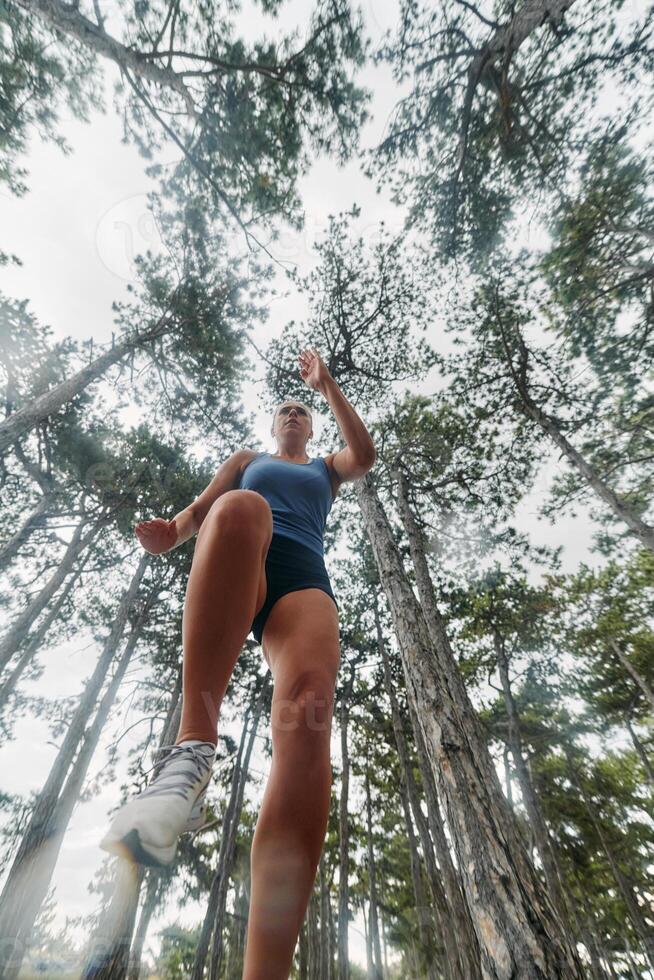 Adventurous Woman Overcoming Forest Obstacles with Determination and Agility. photo