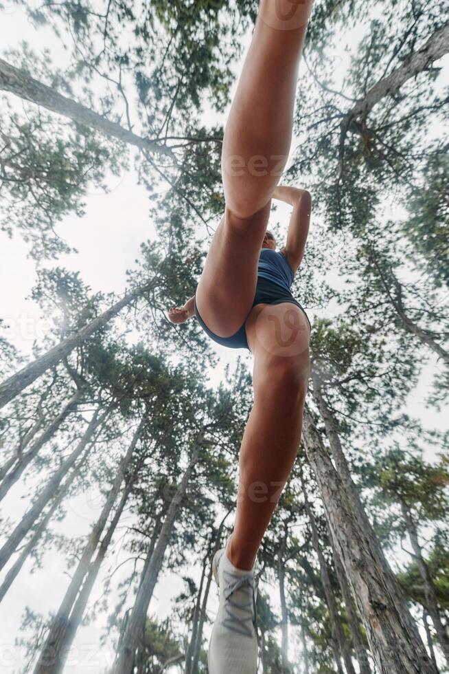 Adventurous Woman Overcoming Forest Obstacles with Determination and Agility. photo