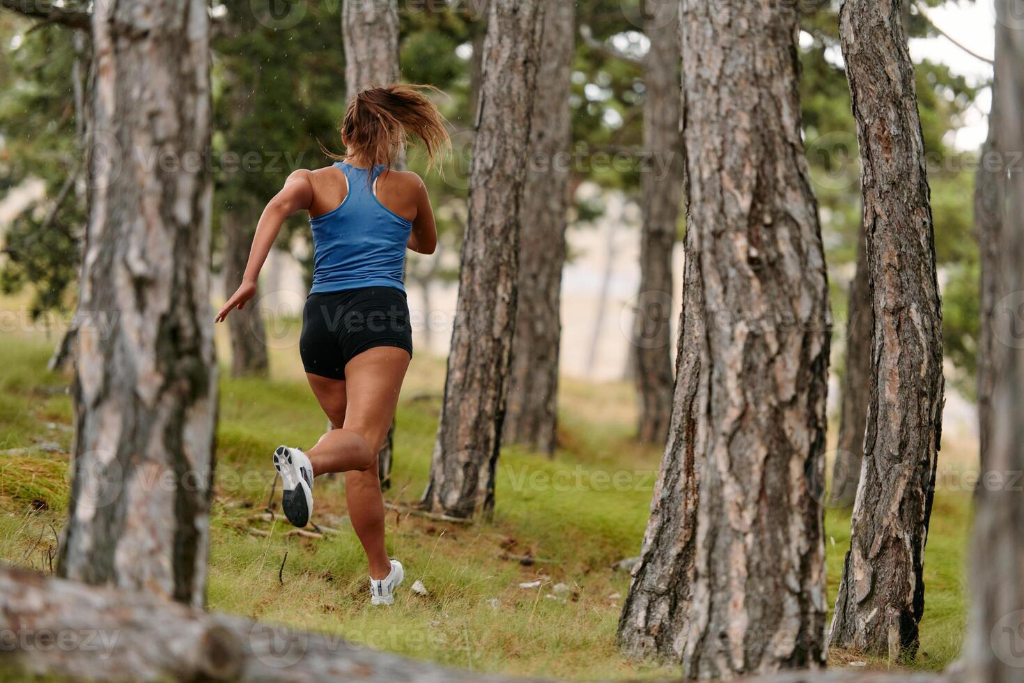 Fearless Woman Conquering Wooden Obstacles in the Dangerous Forest Terrain. photo
