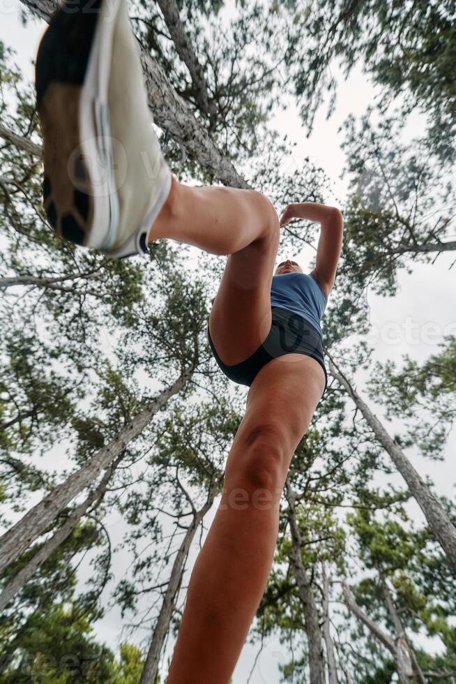 Adventurous Woman Overcoming Forest Obstacles with Determination and Agility. photo