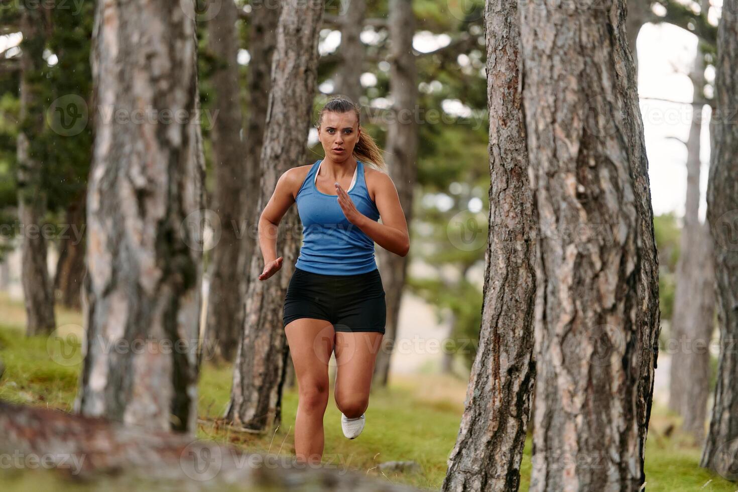 Fearless Woman Conquering Wooden Obstacles in the Dangerous Forest Terrain. photo