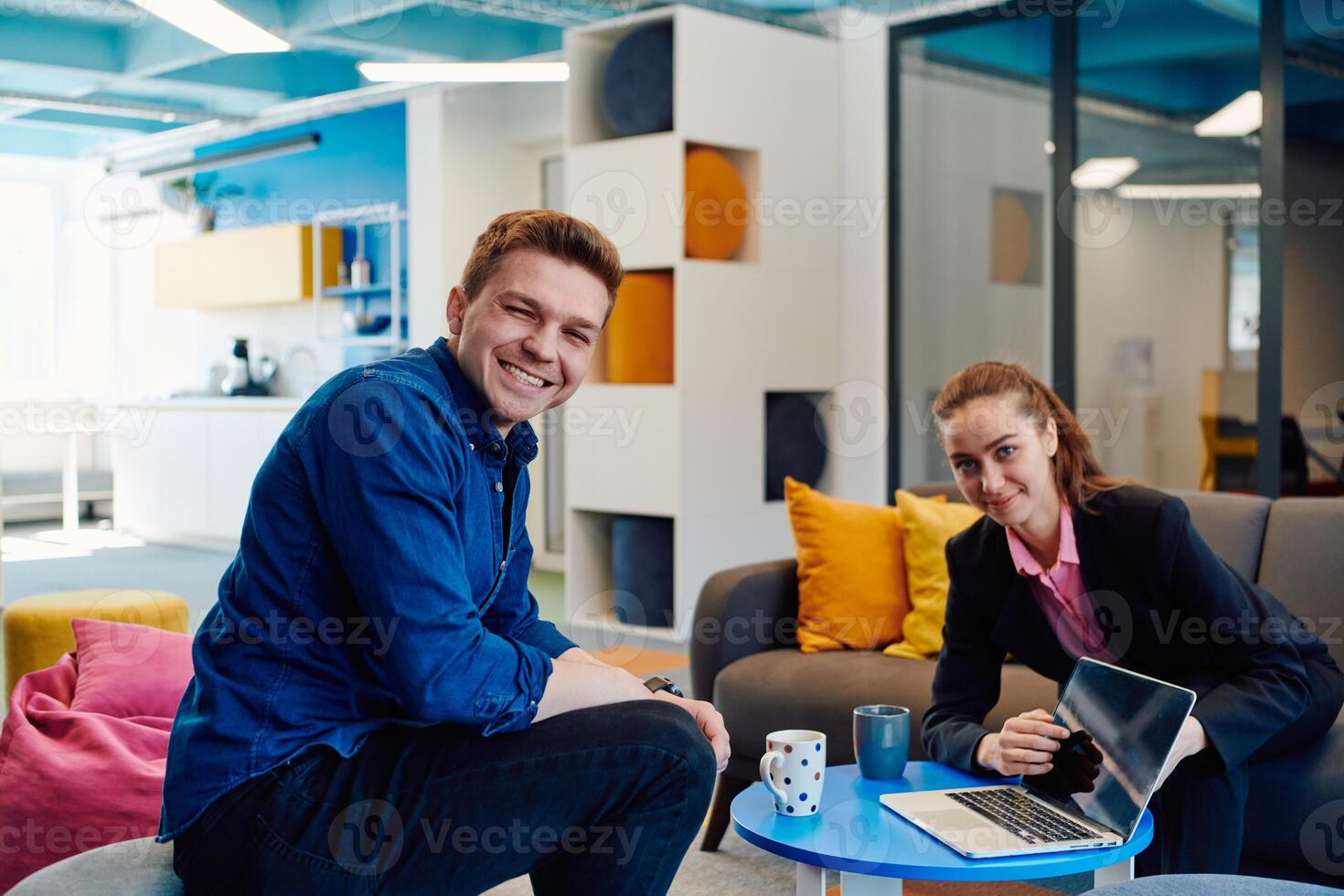 Multiethnic startup business team on meeting in a modern bright open space coworking office. Brainstorming, working on laptop. Group of coworkers walking around in motion blur photo