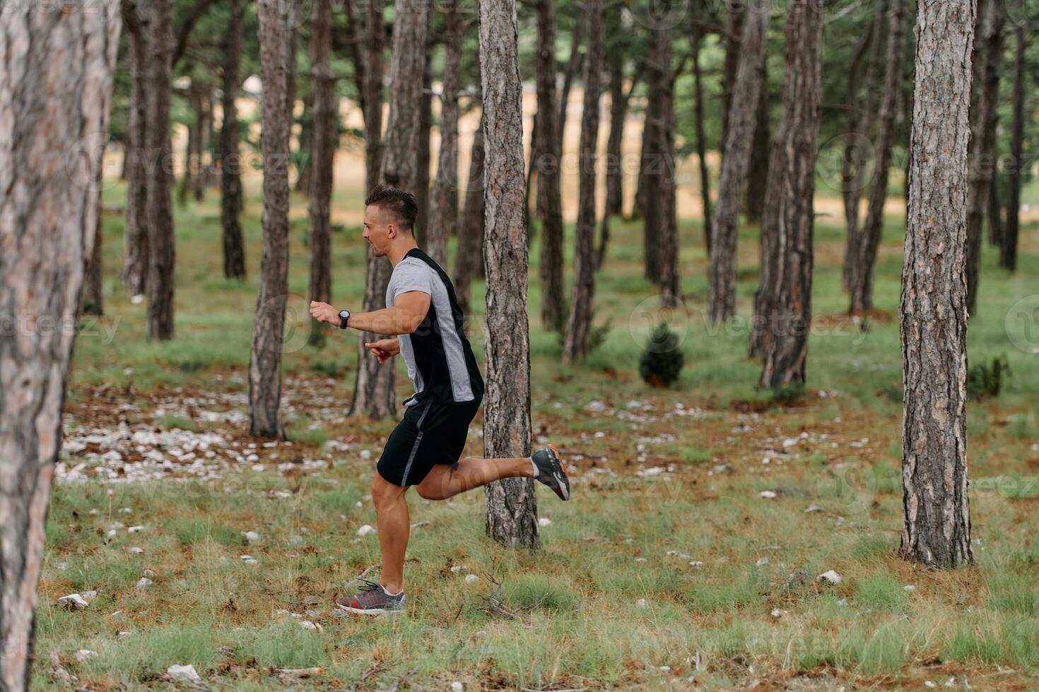 Determined Man Conquering Forest Obstacles with Grit and Speed photo