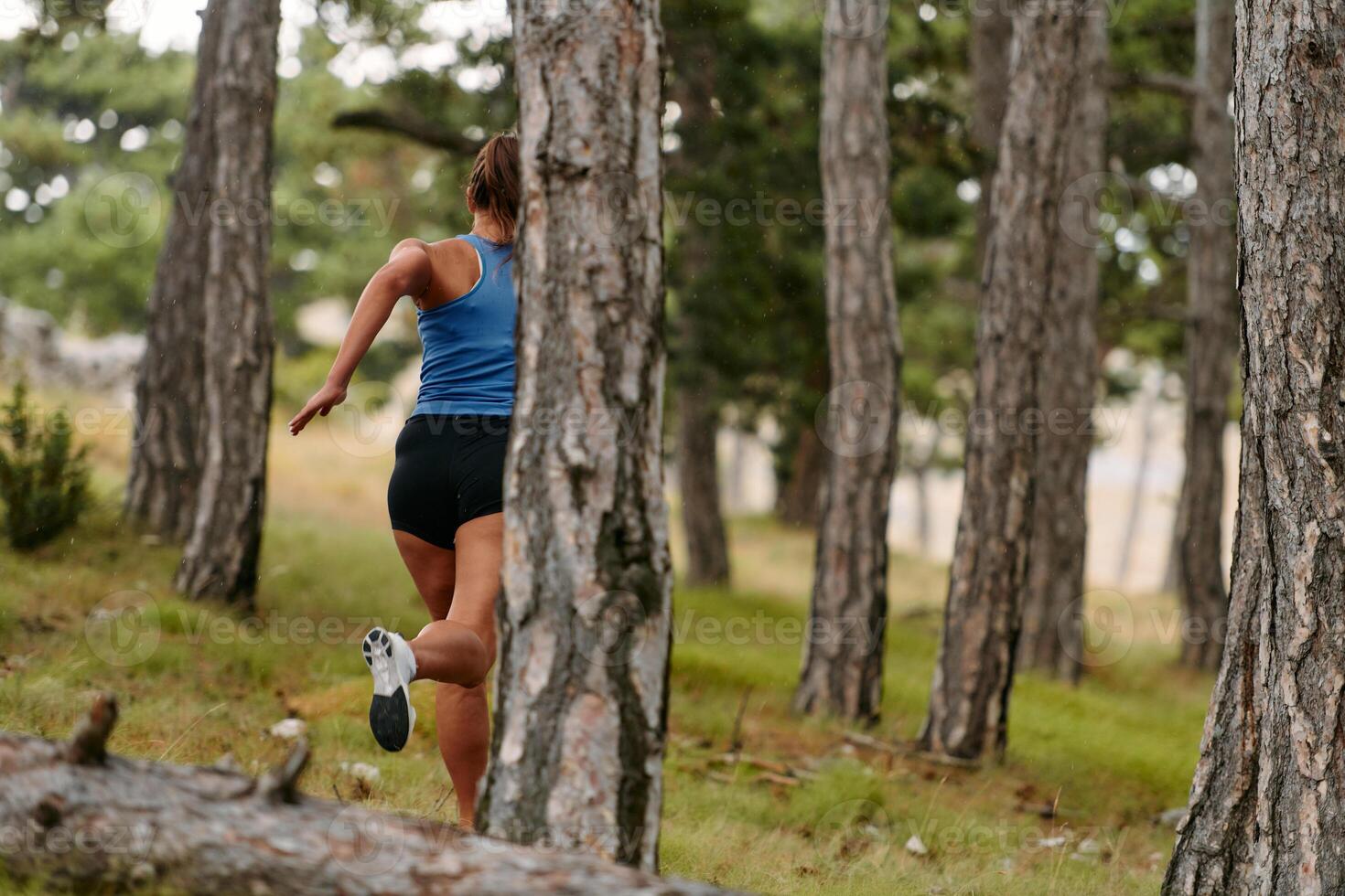 Fearless Woman Conquering Wooden Obstacles in the Dangerous Forest Terrain. photo