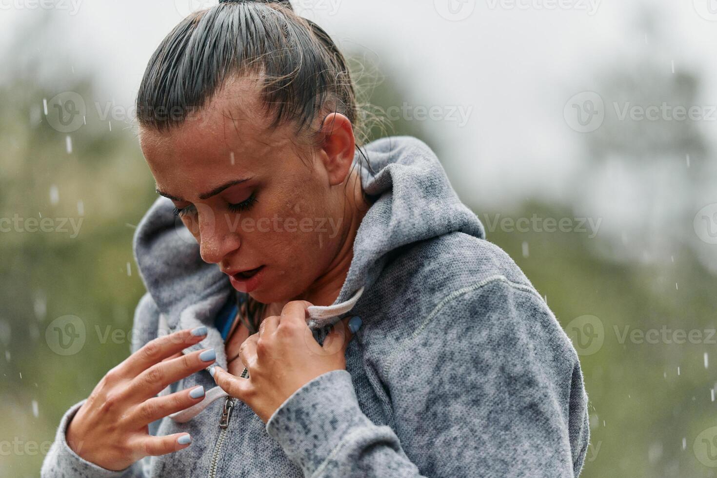 Woman Resting in the Rain After Intense Run photo