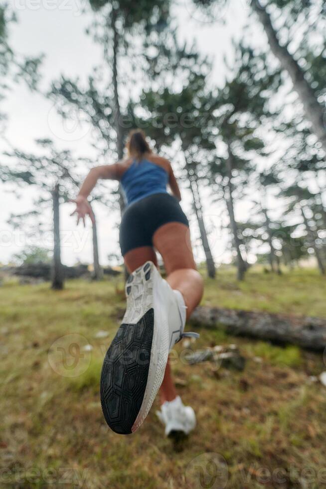 Adventurous Woman Overcoming Forest Obstacles with Determination and Agility. photo