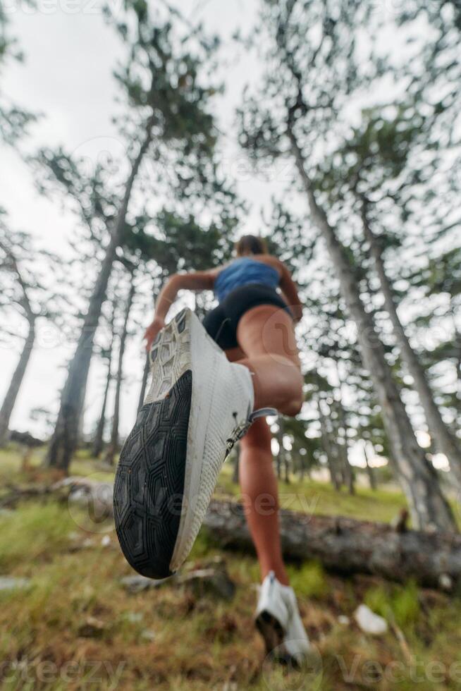 Adventurous Woman Overcoming Forest Obstacles with Determination and Agility. photo