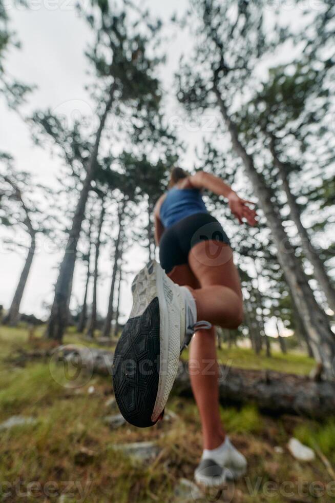 Adventurous Woman Overcoming Forest Obstacles with Determination and Agility. photo