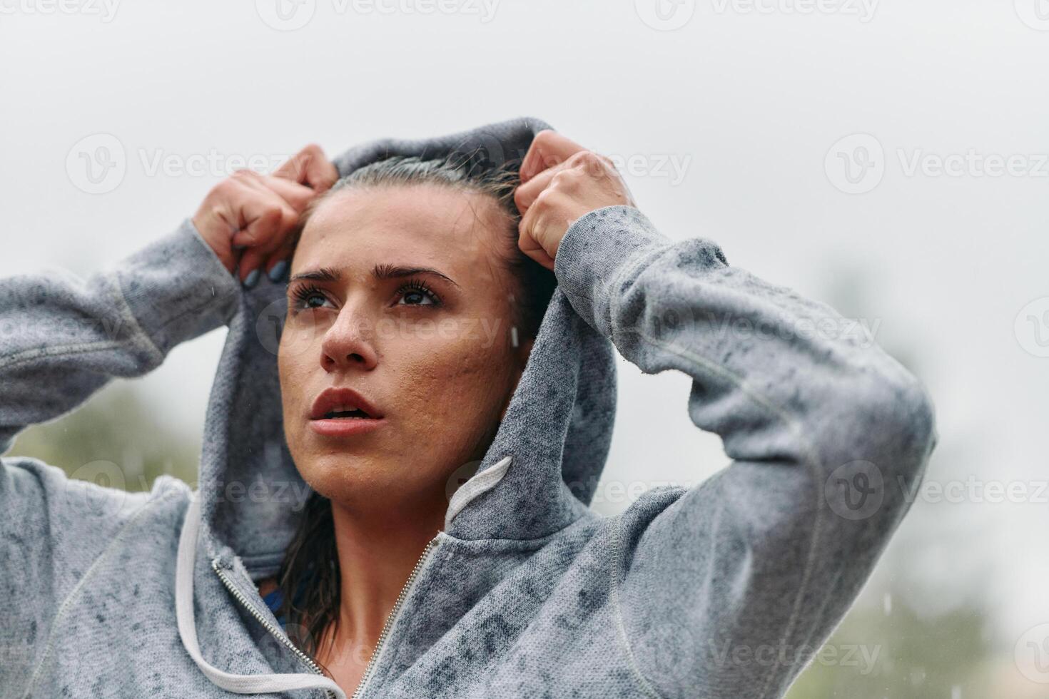 Woman Resting in the Rain After Intense Run photo