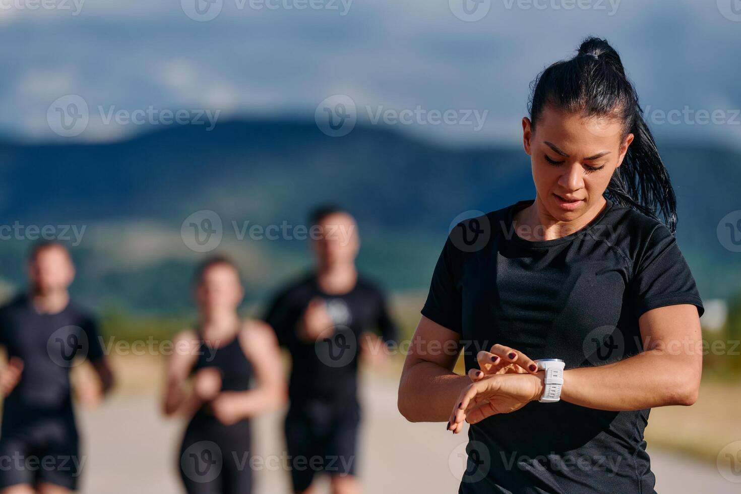 Leader Guiding Athletes on a Sunny Day Run photo