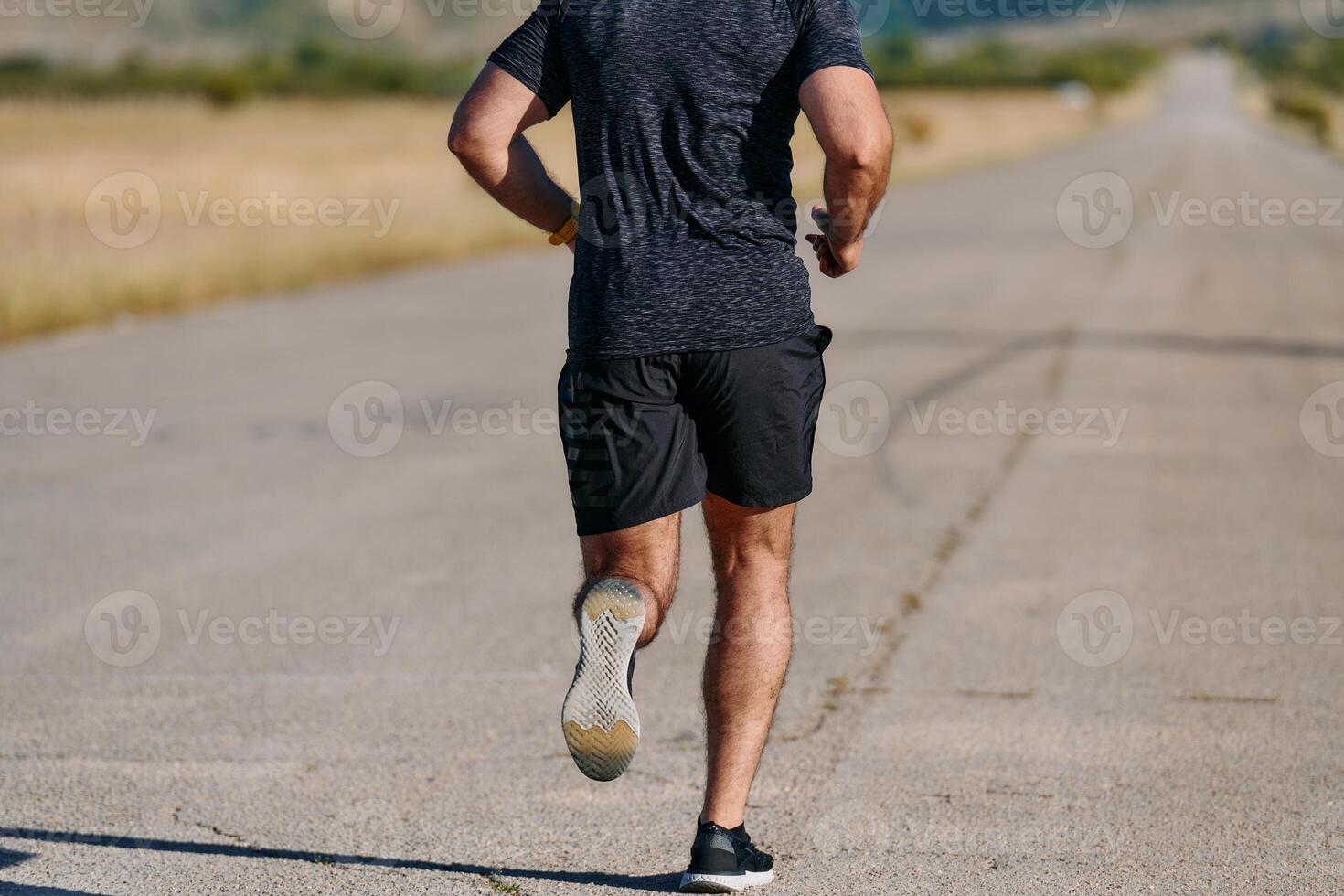 Athletic Man Jogging in the Sun, Preparing His Body for Life's Extreme Challenges photo