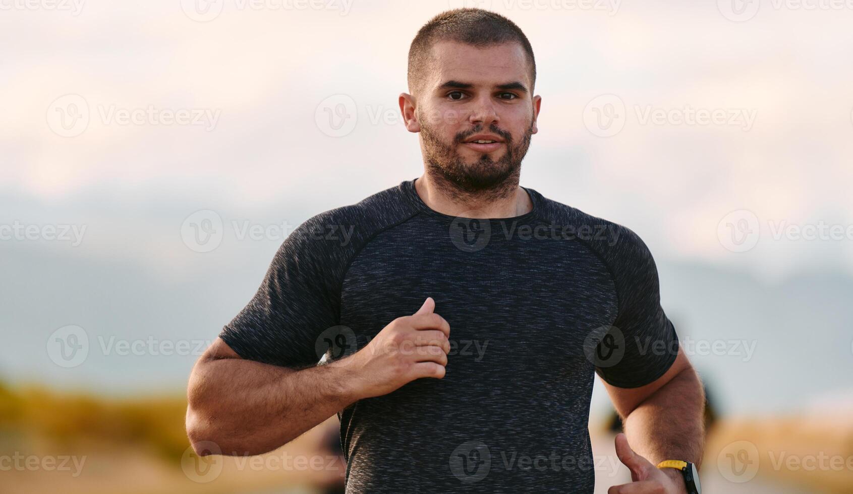 Athletic Man Jogging in the Sun, Preparing His Body for Life's Extreme Challenges photo