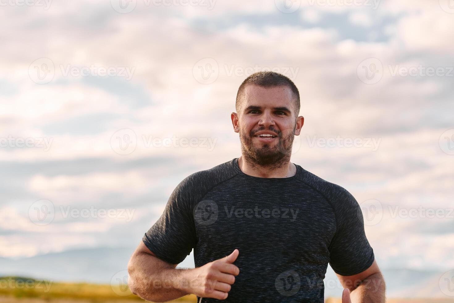 Athletic Man Jogging in the Sun, Preparing His Body for Life's Extreme Challenges photo