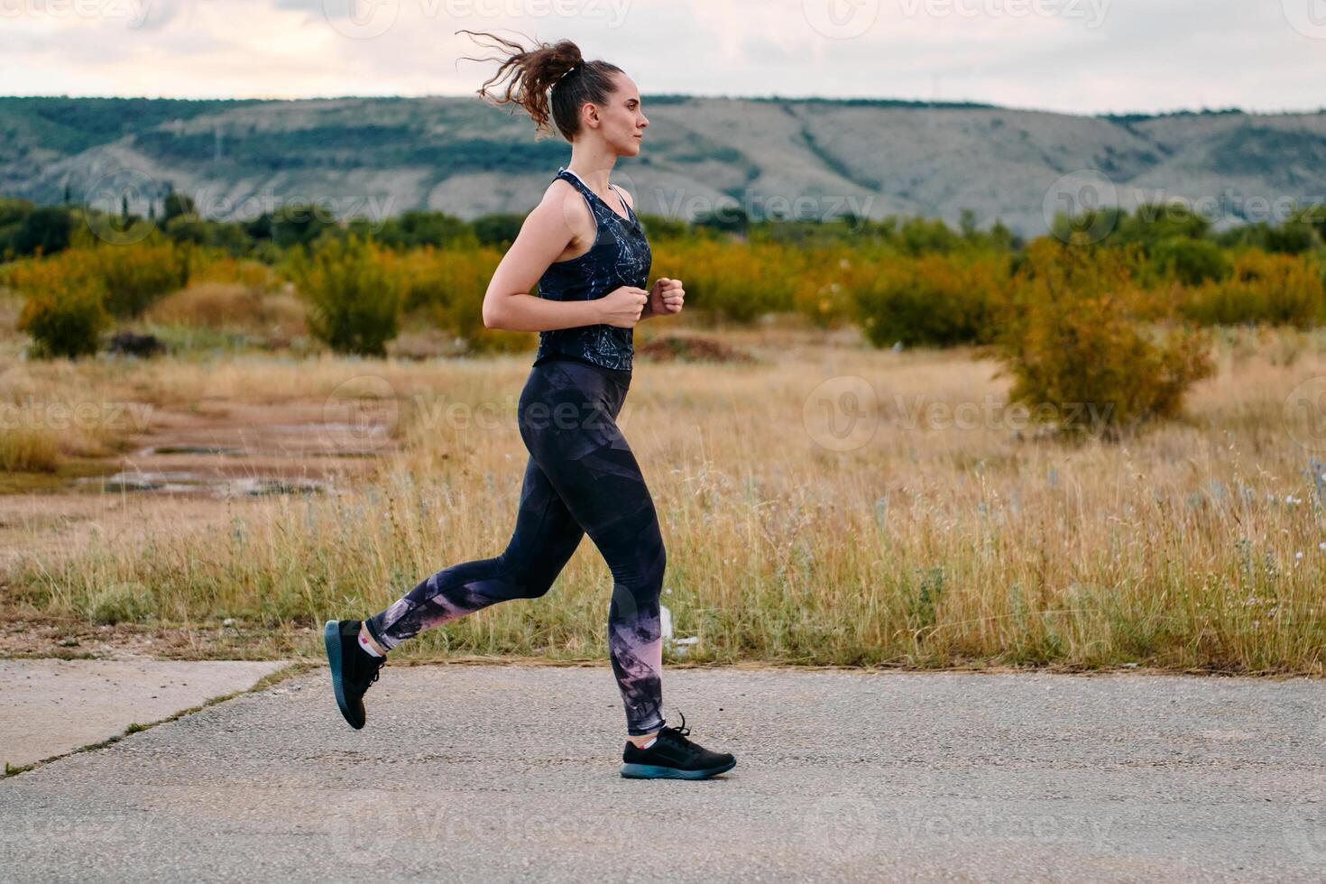 Determined Athlete Running in the Sun amidst Beautiful Nature photo