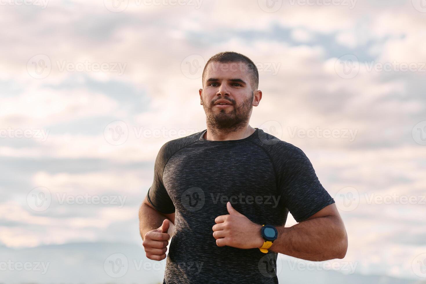 Athletic Man Jogging in the Sun, Preparing His Body for Life's Extreme Challenges photo