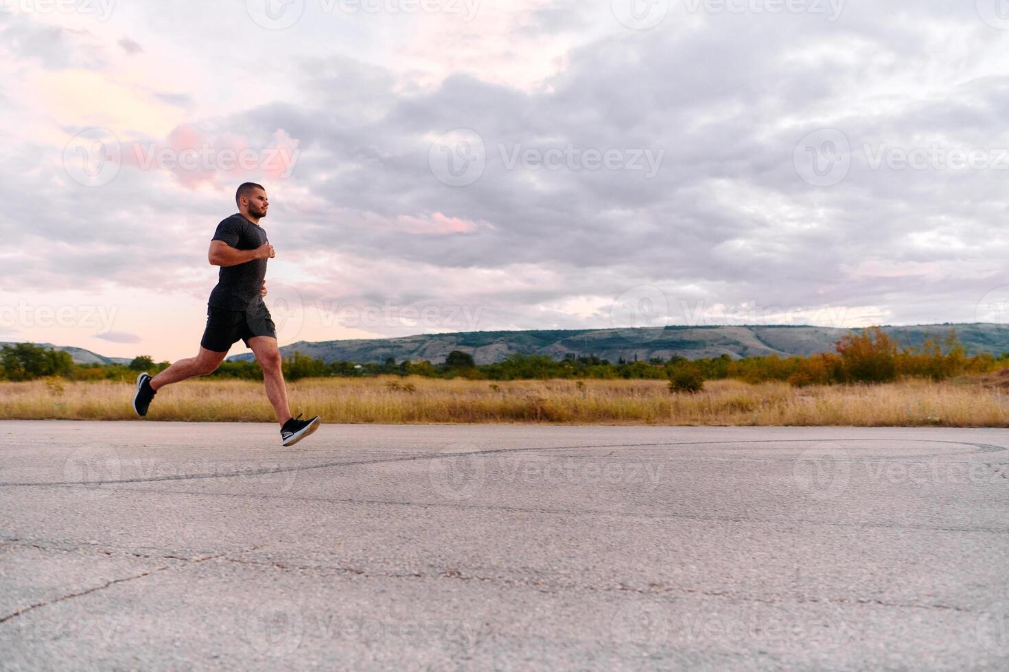 Athletic Man Jogging in the Sun, Preparing His Body for Life's Extreme Challenges photo