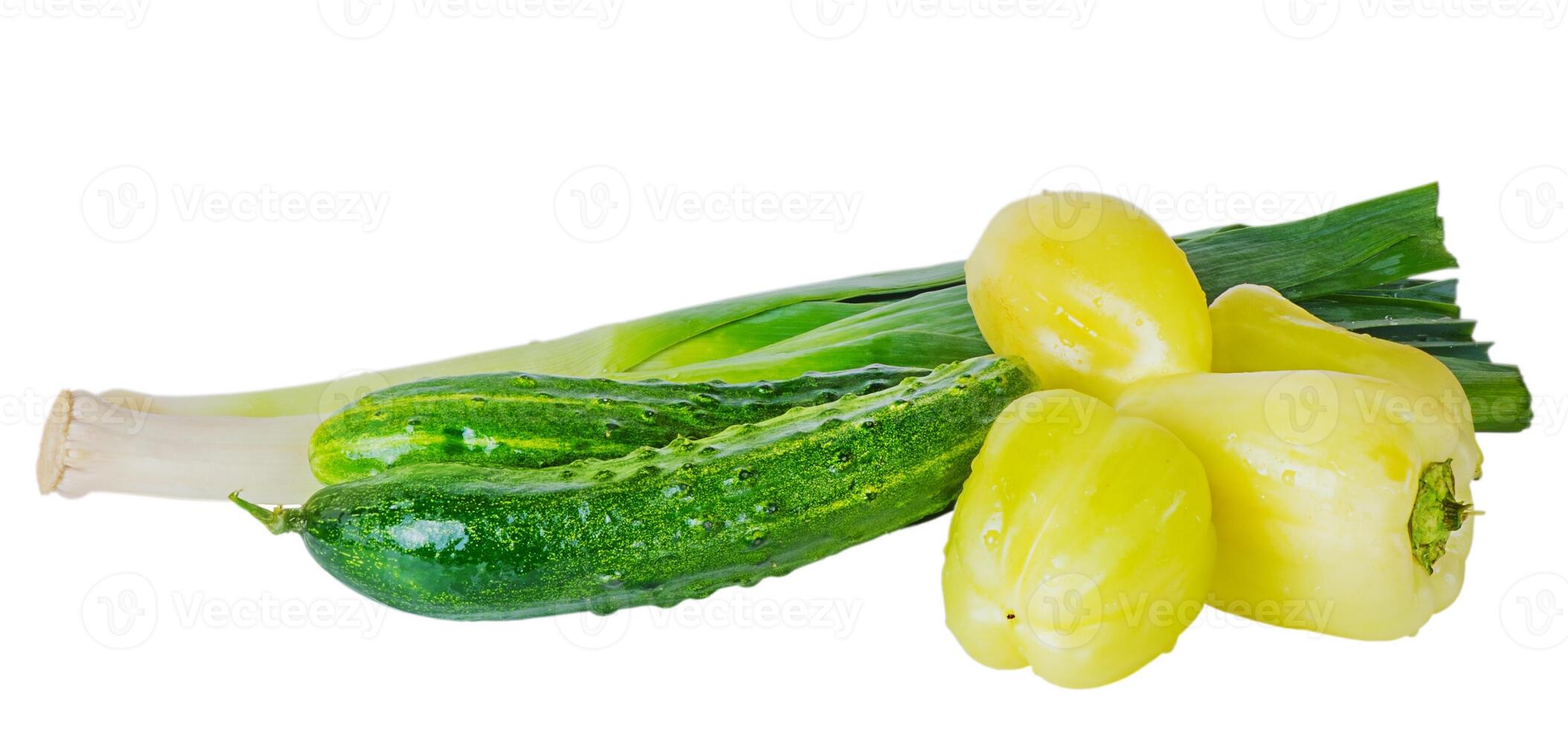Fresh sweet peppers, cucumbers and leeks isolated on white. photo