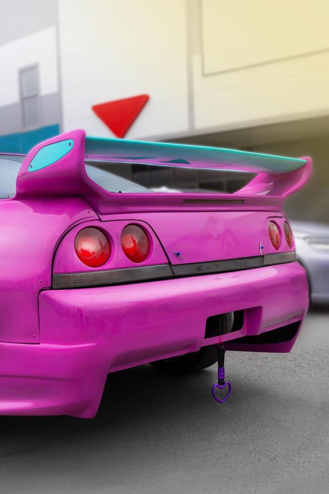 Russia, Novosibirsk, 25.05.2024 Midday, Pink Nissan Skyline R33 1993 back view photo