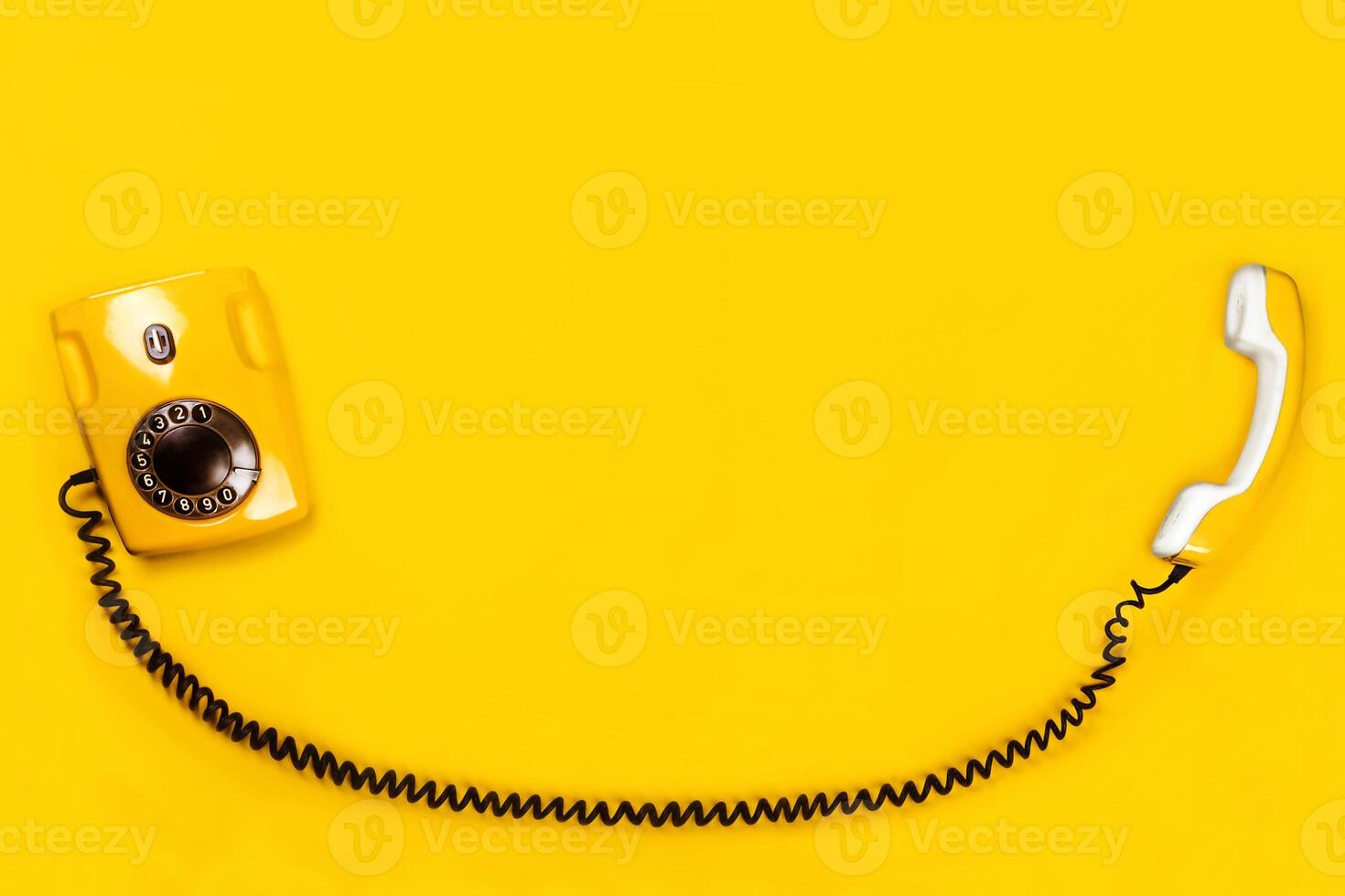 Yellow old stylish Phone, telephone with dial on yellow background copy space for your text flat lay photo