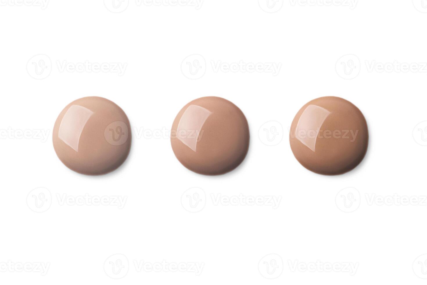 3 Three foundation shade swatches, round shape. Make up smear swatch foundation smudge texture isolated on white background photo