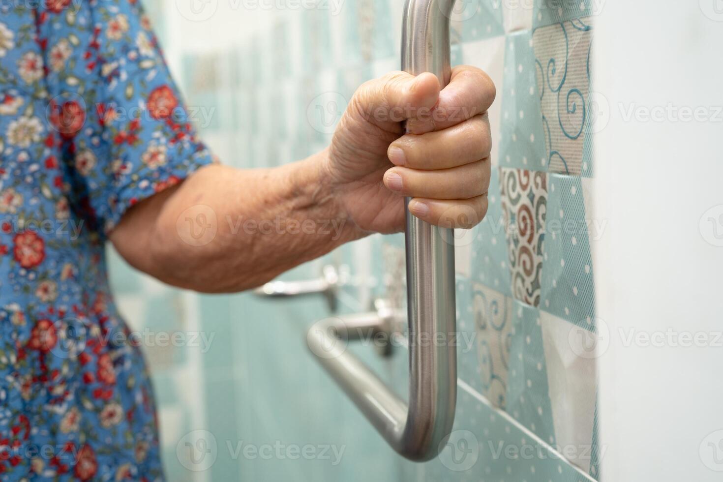Asian elderly woman use bathroom handle security in toilet, healthy strong medical. photo
