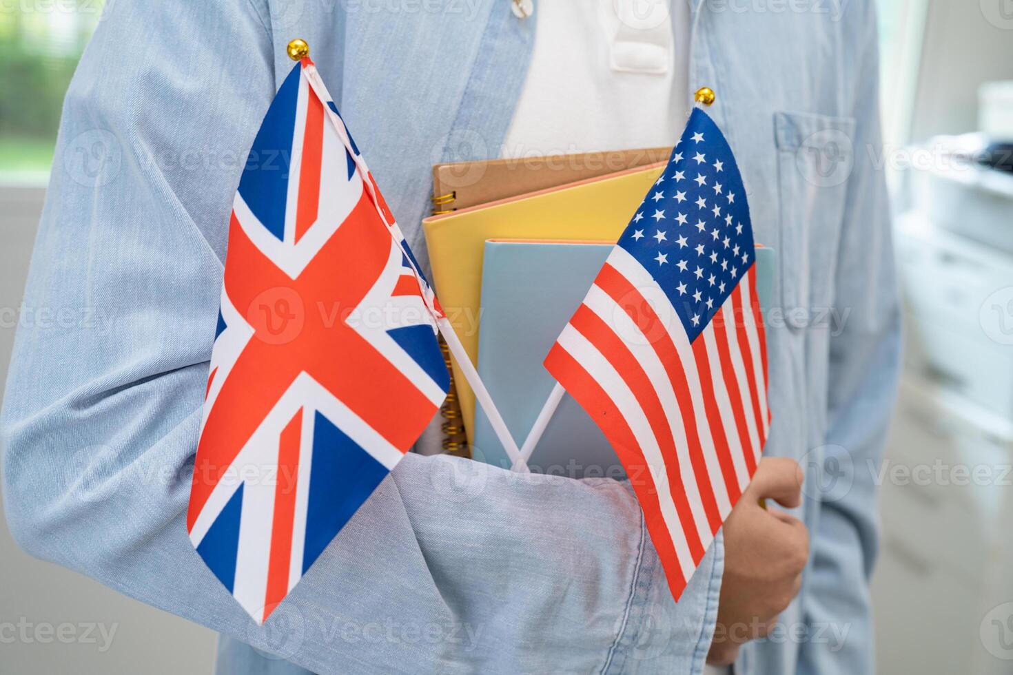 Learn English language, Asian teenage student hold book with flag in course at school. photo
