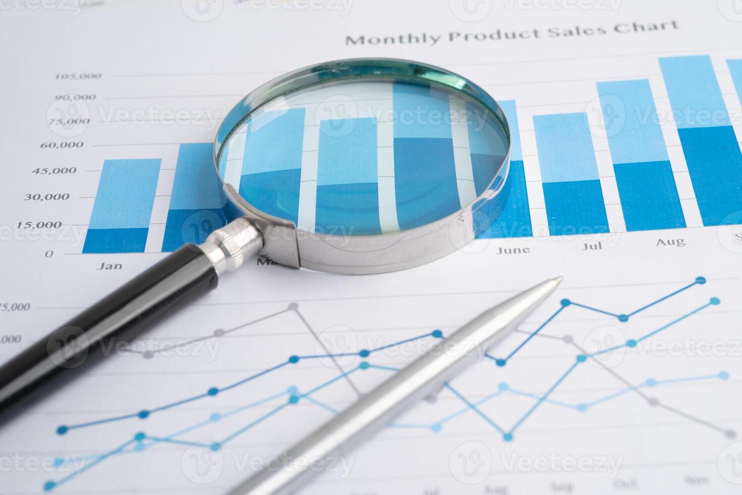Magnifying glass on spreadsheet and graph paper. Financial development, Banking Account, Statistic, Investment Analytic research data economy, Business. photo