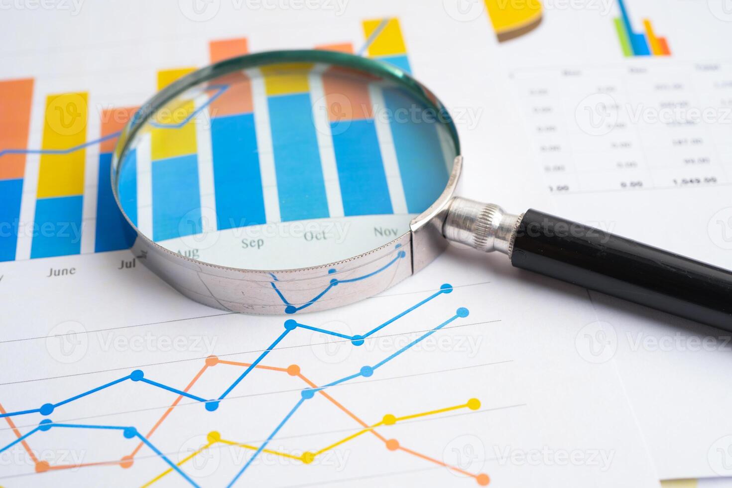 Magnifying glass on spreadsheet and graph paper. Financial development, Banking Account, Statistic, Investment Analytic research data economy, Business. photo