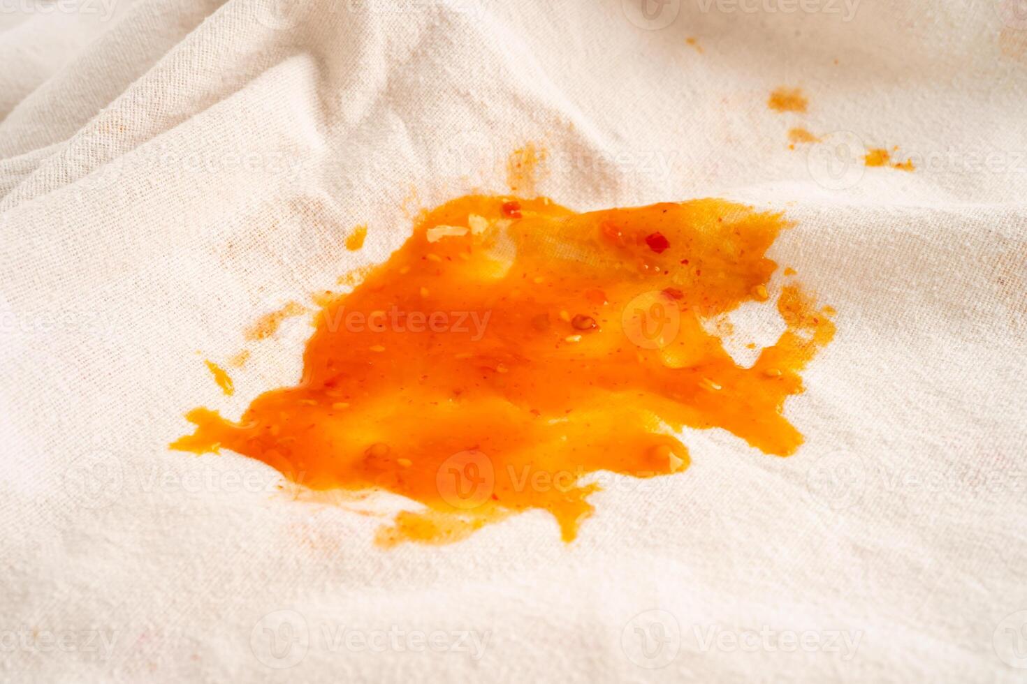Dirty tomato sauce stain or ketchup on cloth to wash with washing powder, cleaning housework concept. photo