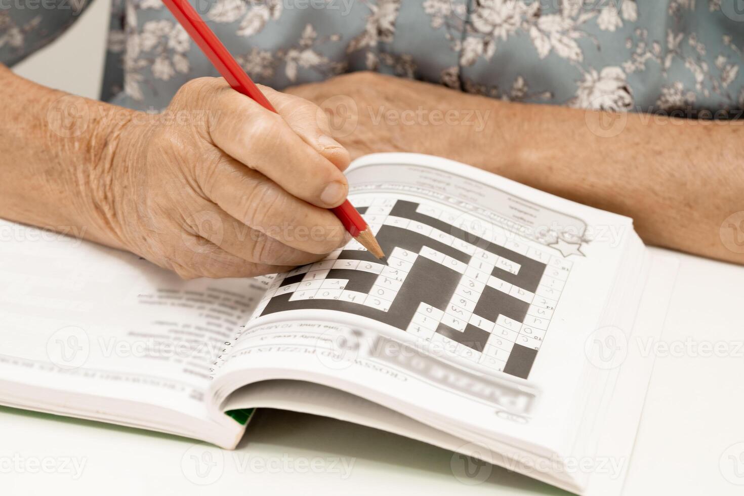 Alzheimer disease AD, Asian elderly woman playing sudoku puzzle game to