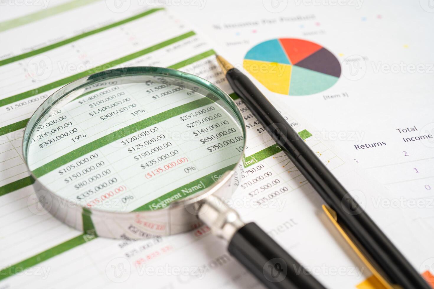 Magnifying glass on spreadsheet and graph paper. Financial development, Banking Account, Statistic, Investment Analytic research data economy, Business. photo