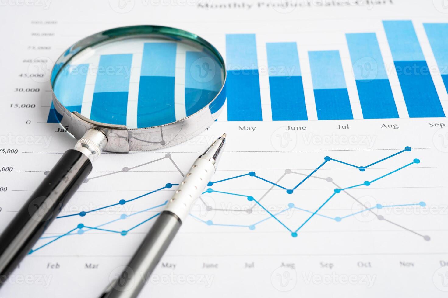 Magnifying glass on spreadsheet and graph paper. Financial development, Banking Account, Statistic, Investment Analytic research data economy, Business. photo