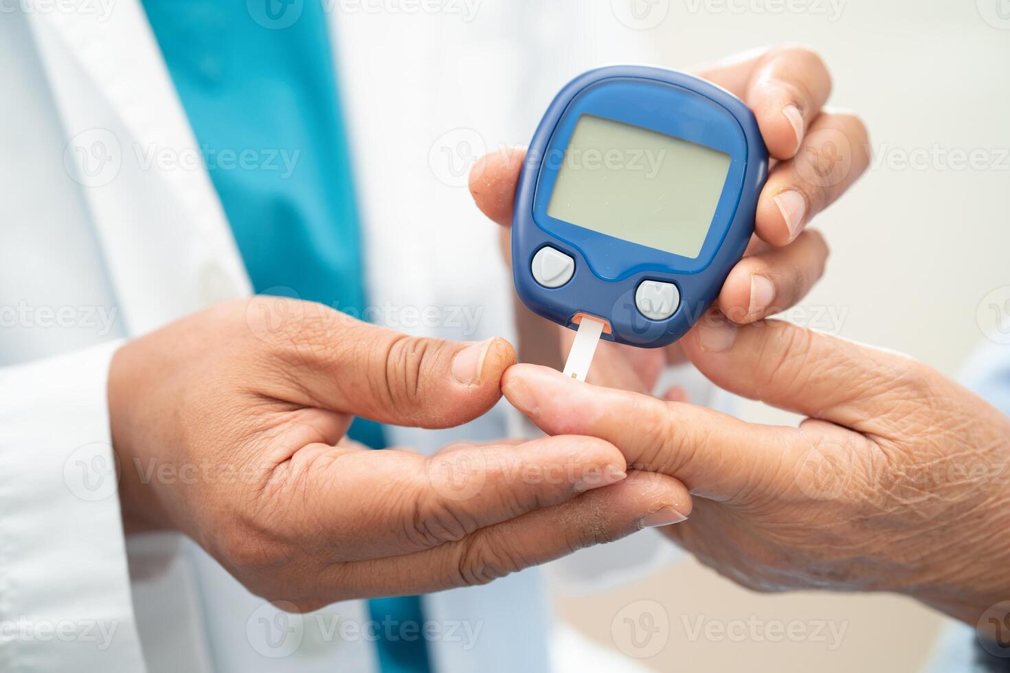 Doctor check diabetes from finger blood sugar level with finger lancet. photo