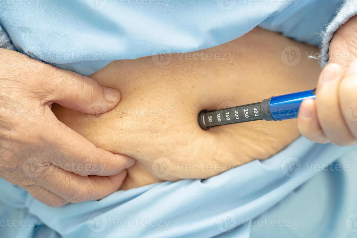 Senior woman patient injecting insulin for treat diabetes. photo