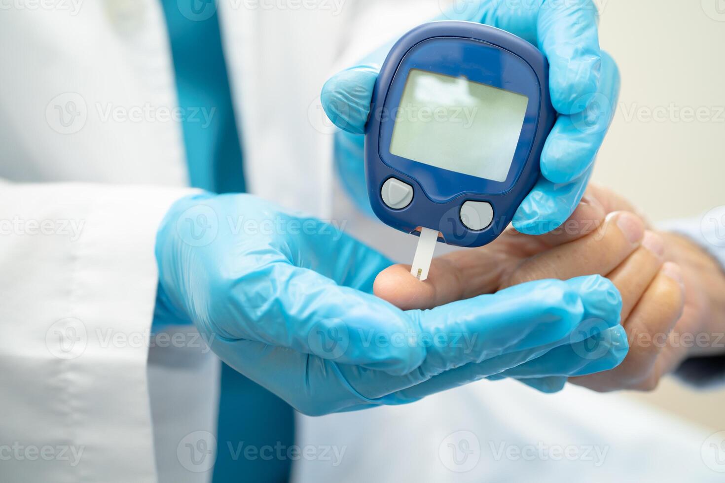 Doctor check diabetes from finger blood sugar level with finger lancet. photo
