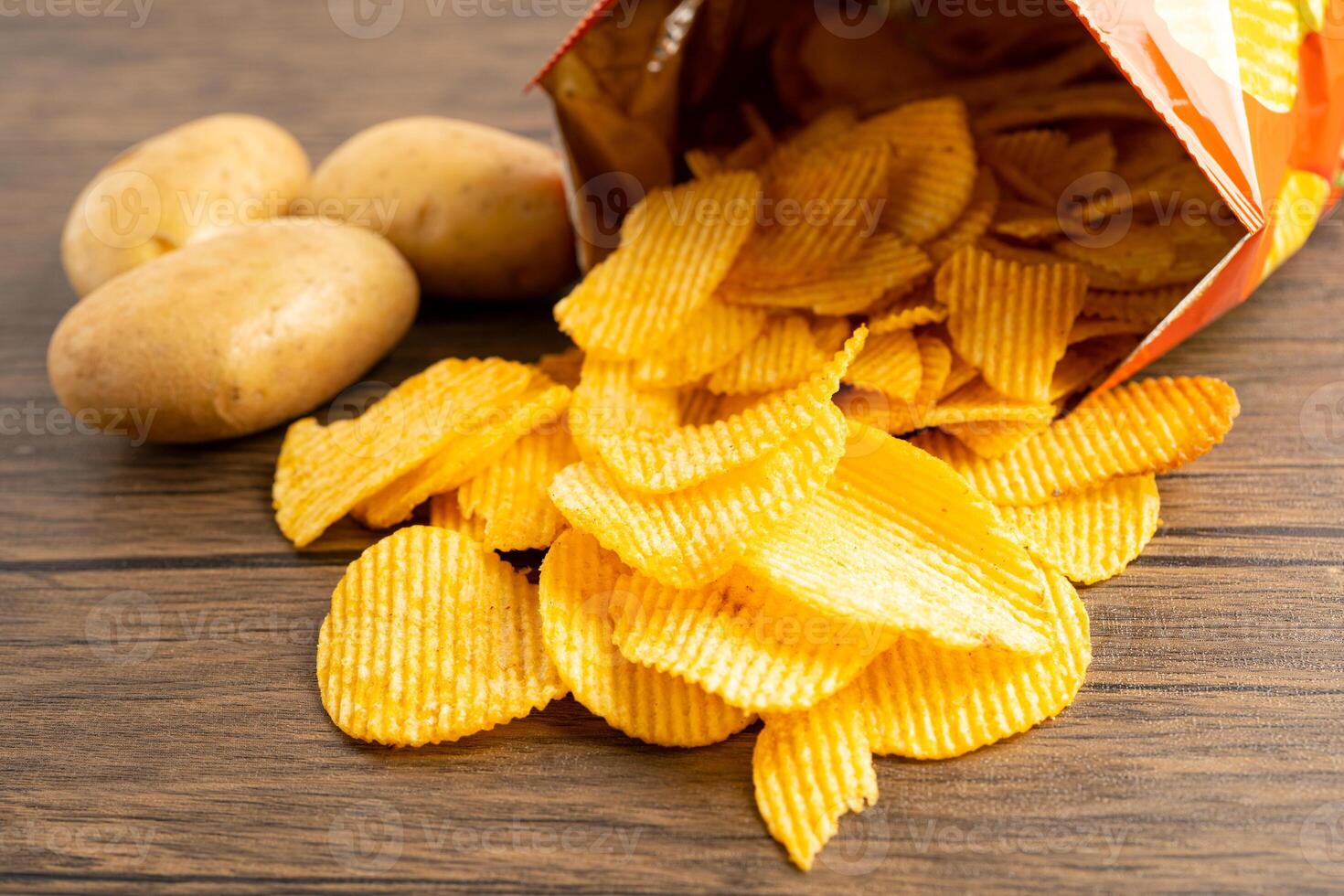 Potato chips, delicious BBQ seasoning spicy for crips, thin slice deep fried snack fast food in open bag. photo