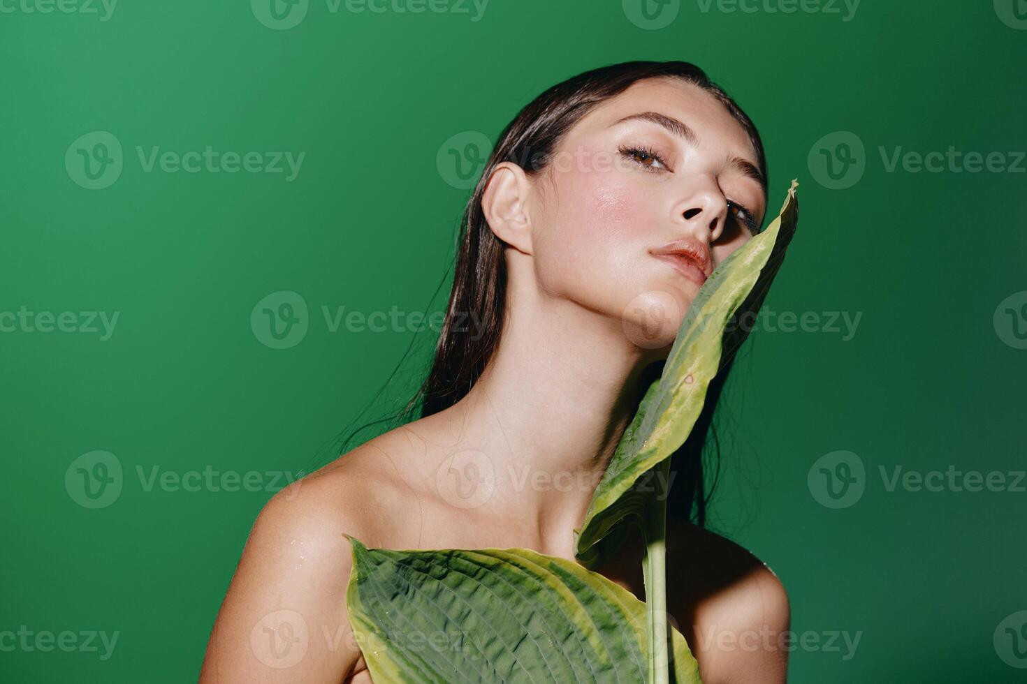 Fresh Beauty. Young Woman's Pretty Portrait with Green Background photo
