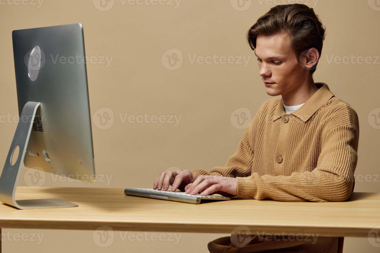 Young Man Working on Computer in Office photo