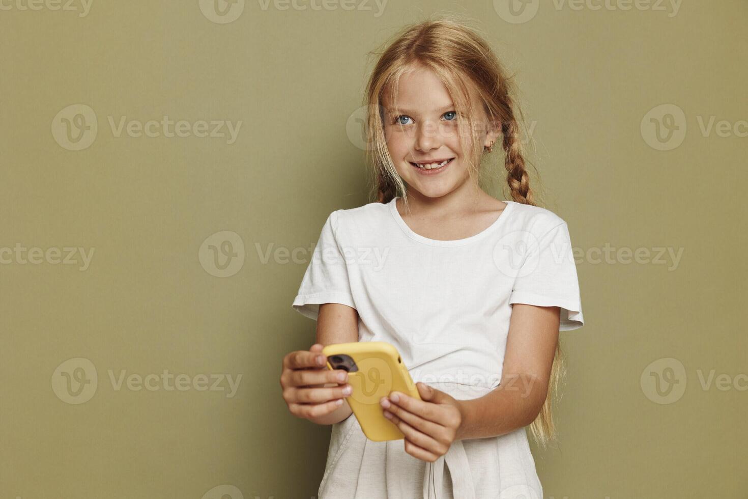 Joyful Young Schoolgirl Holding a Pink Dress with a Bright Smile in Isolated Portrait photo