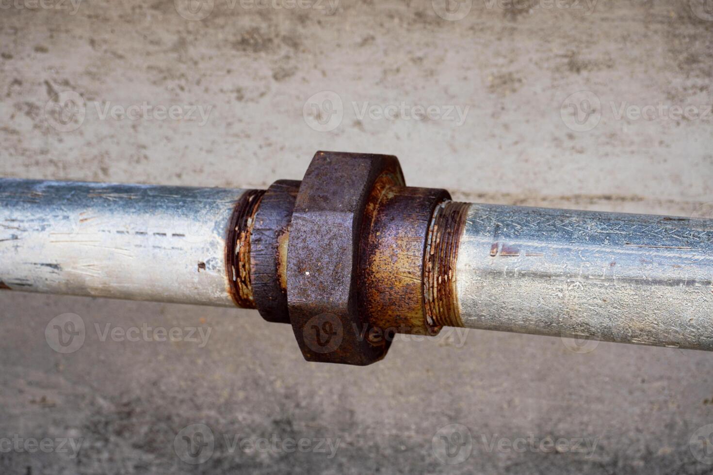 Rusty old metal pipe with valve and bolt photo
