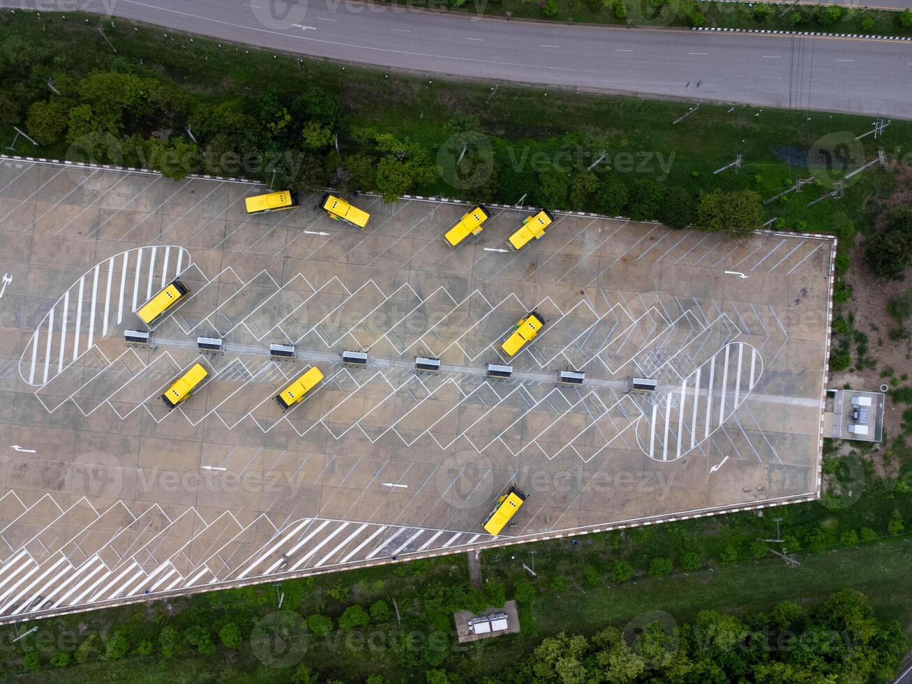 Aerial view of the electric bus charging station. Yellow electric city bus charging parking at charger station with plug cable. Electrified transport future mobility e-motion. photo