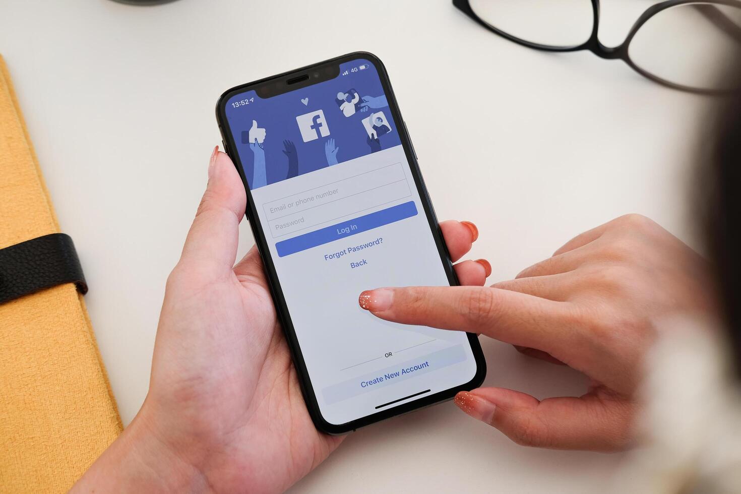 CHIANG MAI ,THAILAND - JAN 19, 2020 . Woman using iPhone XS to use facebook photo