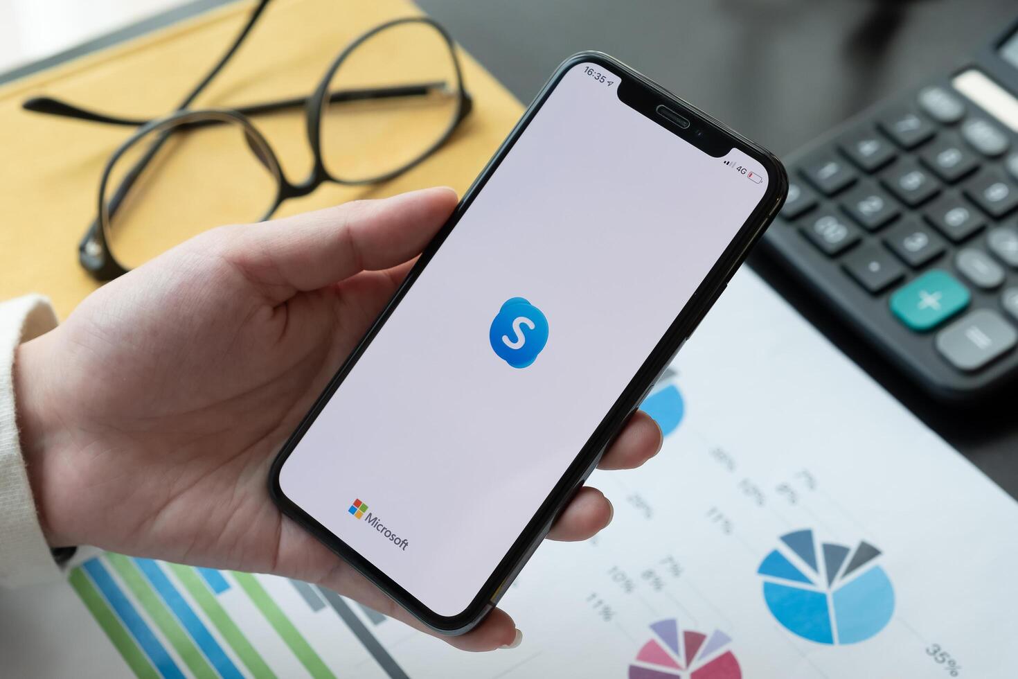 CHIANG MAI,THAILAND - APR 06, 2020 . Woman holding iphone Xs with Skype application, Skype is part of Microsoft, photo